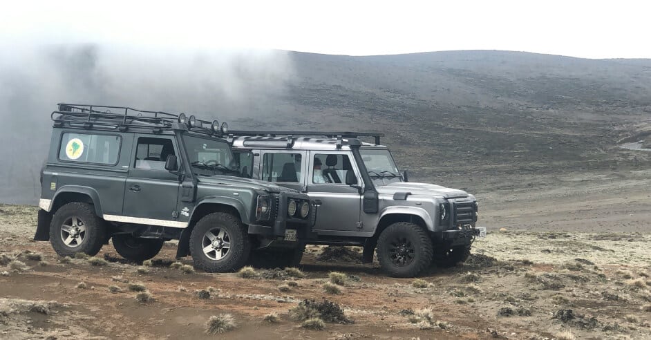 the land rover driving through rugged terrain